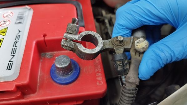 بررسی بصری بست باتری خودرو برای تشخیص شل شدن یا خرابی